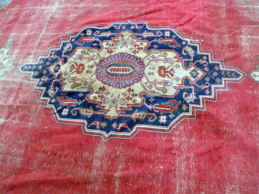 A large Persian floor carpet decorated stylised flowers on a red ground 354cm x 453cm (wear) - Image 2 of 9