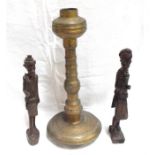 An Eastern Brass candle holder 43cm high and two African carved wooden figures (3)