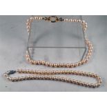 A pearl necklace with silver clasp 35cm long and another similar 41cm long