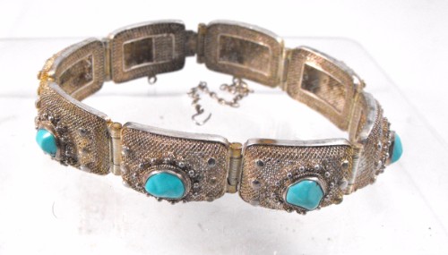 A Chinese silver bracelet set with natural turquoise