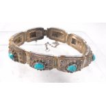 A Chinese silver bracelet set with natural turquoise