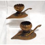A pair of Egyptian/Arabic candlesticks in the form of a flower on a lily pad with a coiled snake 6cm