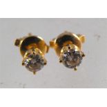 A pair of yellow metal diamond stud earings