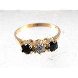 A 9ct gold three stone ring set with two sapphires
