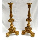 A pair of Italian carved wood and gilded candlesticks with acanthus leaf and swag decorations 51cm