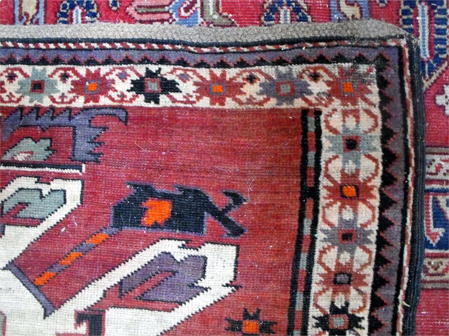 A Caucasian rug, the central panel decorated with three repeating geometic medallions within a - Image 3 of 4
