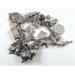 A silver charm bracelet, 77grams