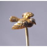 A Victorian yellow metal stick pin, modelled as a dove in flight 6cm high