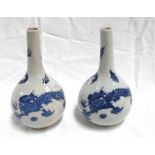 A pair of Chinese style transfer printed bottle vases, decorated dragons 17cm high