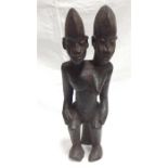 An African hardwood carving, depicting a two headed male/female figure 48cm high