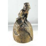 A 19thC Russian bronze table bell, a young boy with a grain scoop on a grain mound, cyrillic
