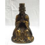 A Chinese gilt metal figure, in the form of a seated magistrate, 12 character mark to the back