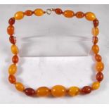 A string of antique graduated amber beads with 9ct gold clasp 24.5gms