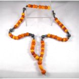 A string of yellow amber and white metal prayer worry beads Condition Report total weight with the