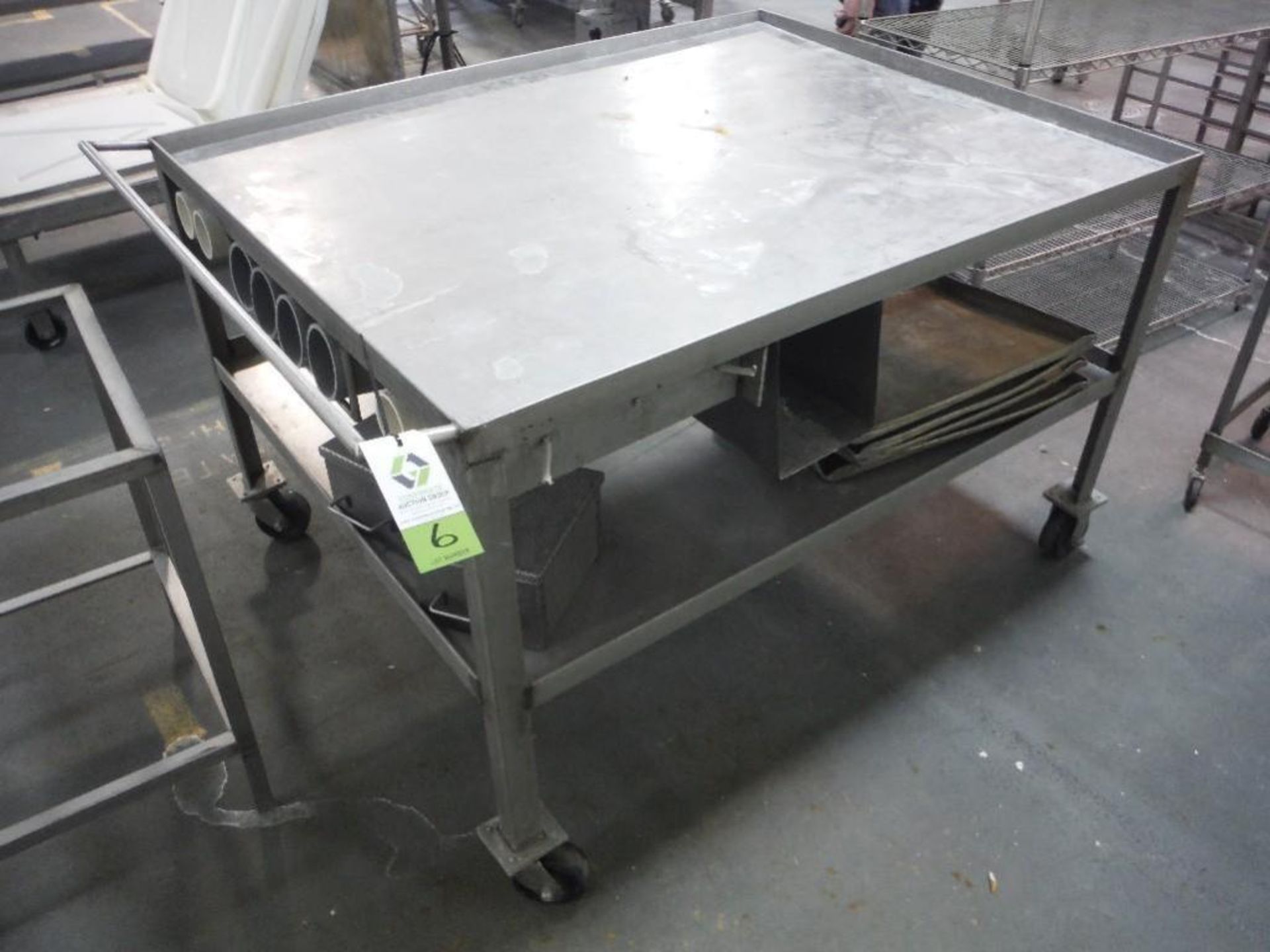 SS table, 60 in. long x 49 in. wide x 38 in. tall, undershelf, on wheels, **(Located in: Marshall, M