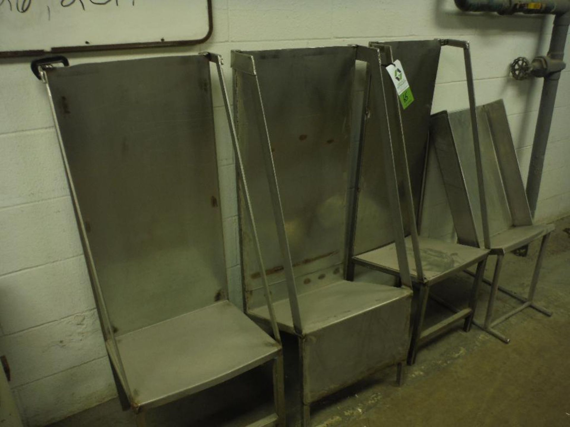 (4) SS slant bottom pack off tables (LOT). Rigging Fee: $50