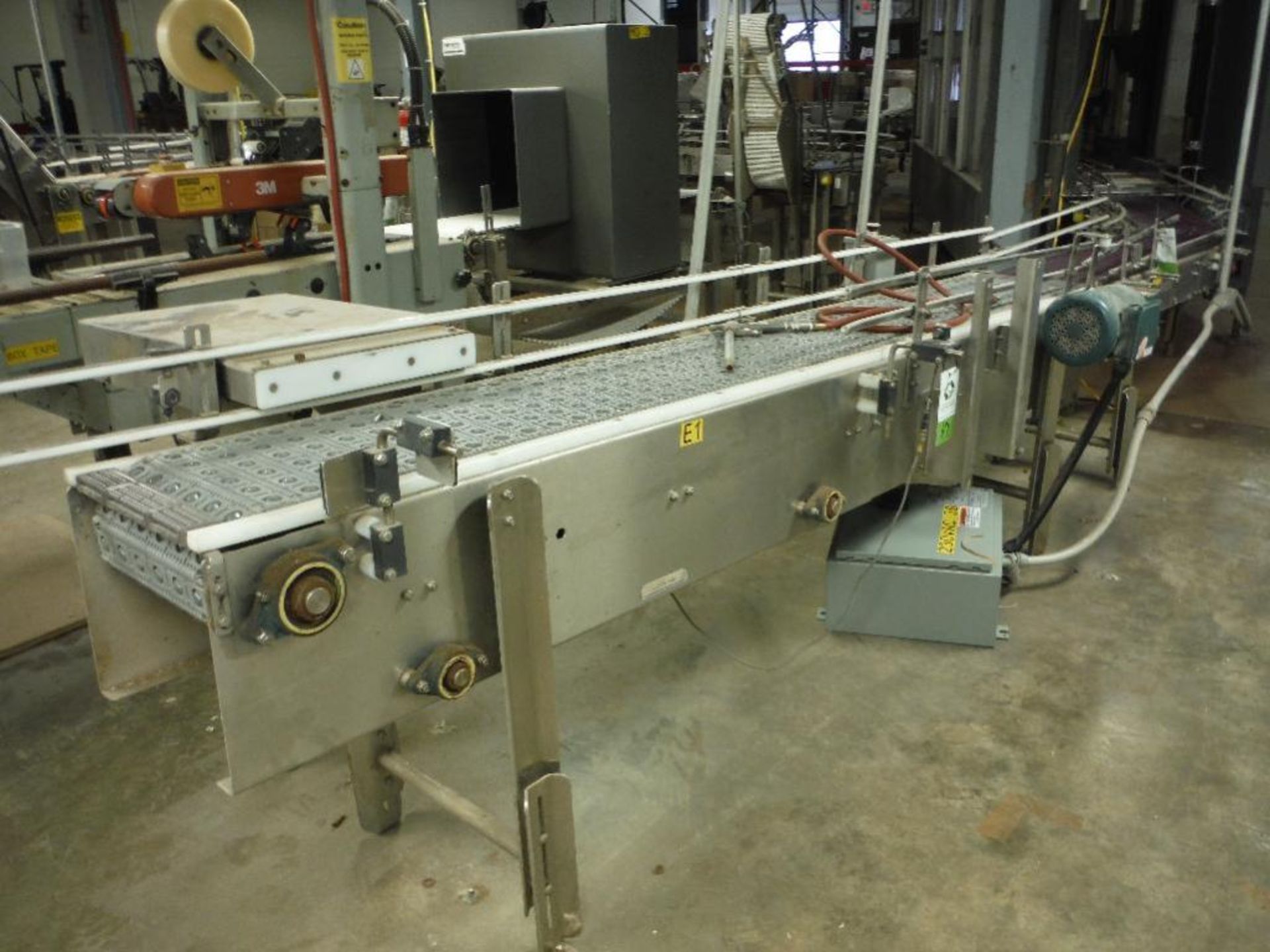 SS infeed conveyor, 102 in. x 12 in., w/ drive and reject ram. Rigging Fee: $150