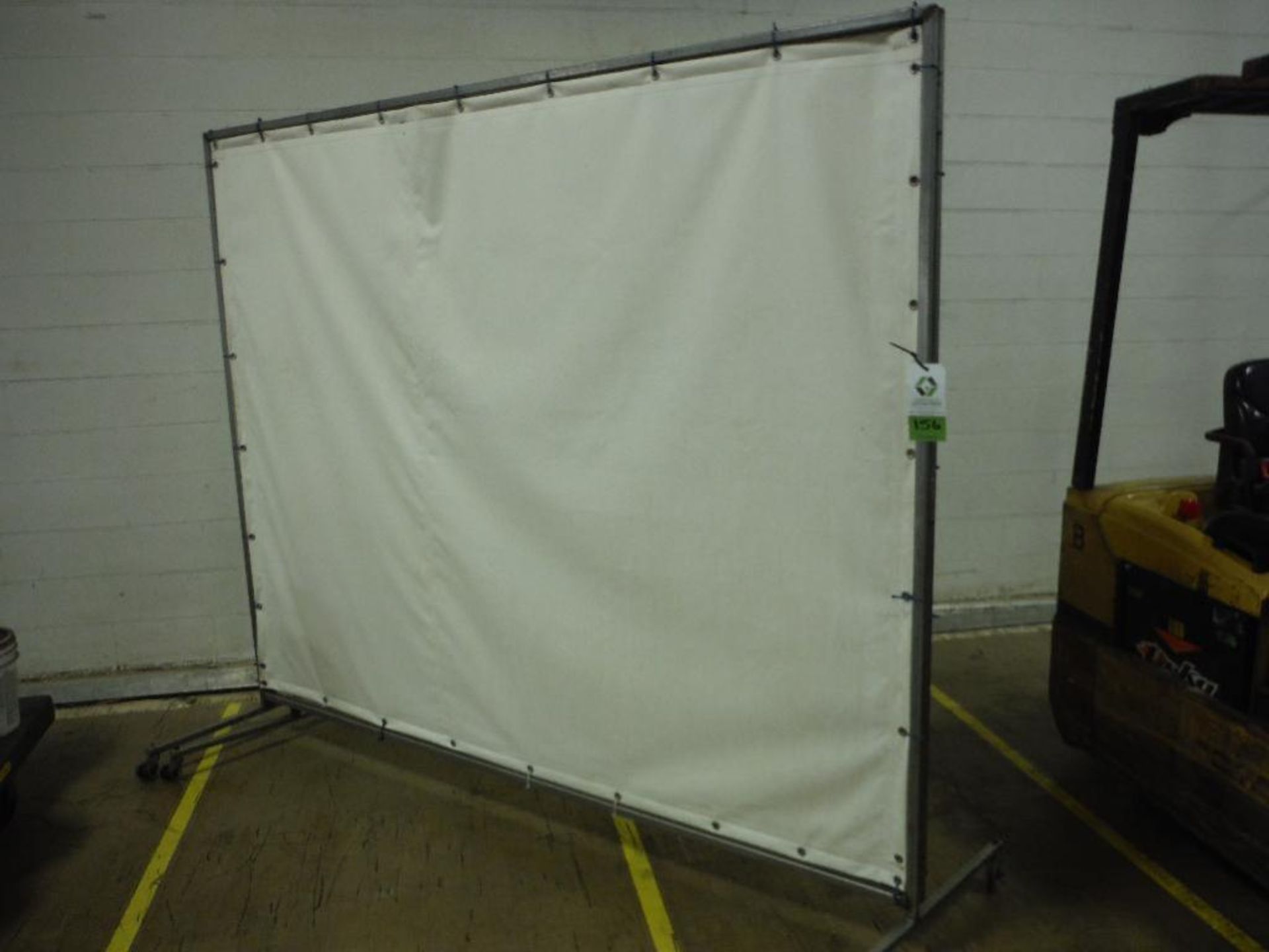 Folding wash down canvas curtain, 16 ft. x 7 ft. tall, on casters. Rigging Fee: $25