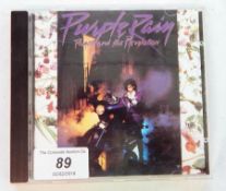 A signed CD album of "Purple Rain" by Prince