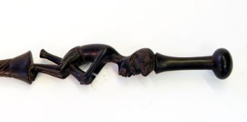 Hardwood walking stick, spirally twisted with carving of a tribal man playing traditional drum,