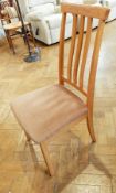 A Wyatt & Newton set of four oak dining chairs with splat backs,