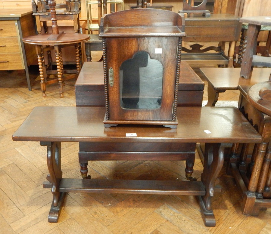 A reproduction oak coffee table with rectangular top, and supported by central stretcher,