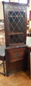 A reproduction carved oak corner cupboard with lunette carved frieze,
