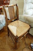 A Victorian hardwood chair, rush seated, railback,