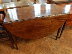 Georgian mahogany drop flap table with rounded ends, raised on square tapering legs,