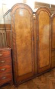 Queen Anne style walnut veneer dome-top double wardrobe enclosing hanging space,