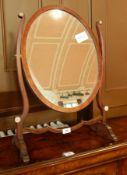 Georgian style mahogany swing frame mirror, the oval plate with elegant supports, on splayed legs,