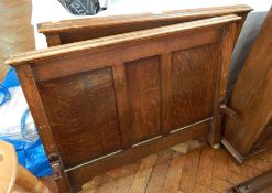 A pair of oak linenfold carved panelled headboards,