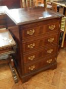 A reproduction mahogany record cabinet with four drawer dummy front on bracket feet,