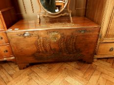 Eastern carved hardwood chest with sailing junk decoration and brass clasp, on stepped bracket feet,