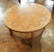 An oak circular quartered oak top coffee table, with undershelf on square legs, dia.