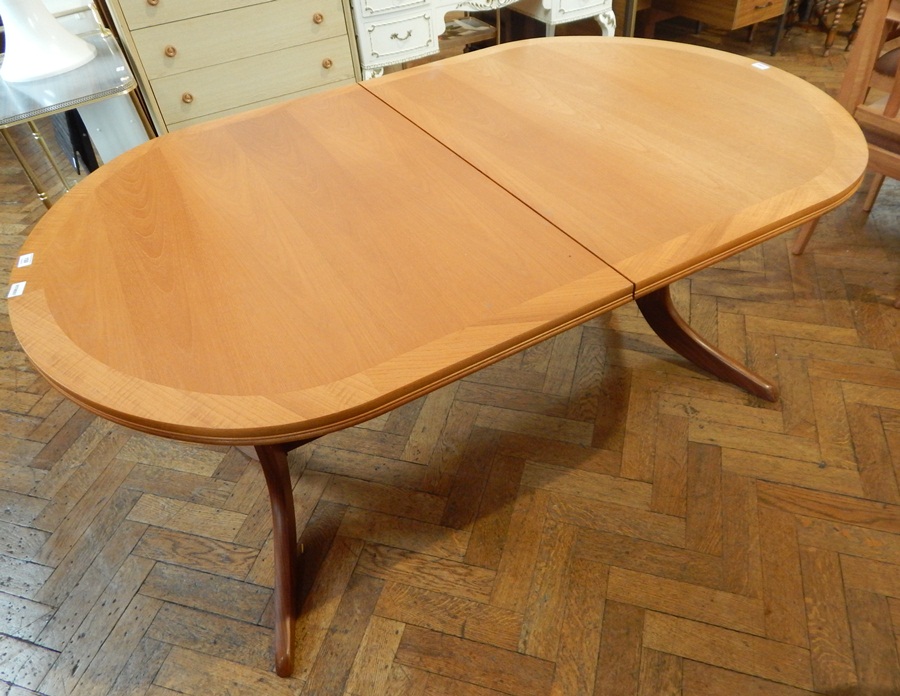 A Nathan Furniture extending dining table with extra leaf,