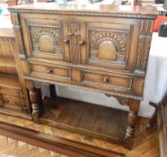 A reproduction carved oak court cupboard, with pair of arcaded panelled doors,