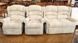 A three piece suite comprising: a two seater sofa and a pair of reclining armchairs with geometric