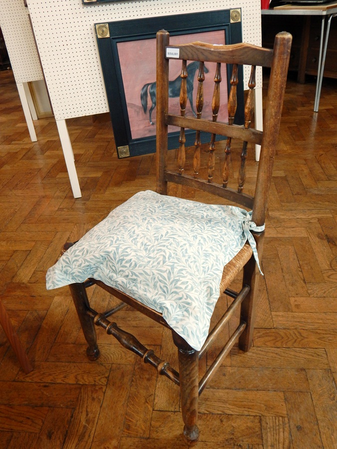 A set of 19th century oak spindle back dining chairs with rush seats on turned legs united by