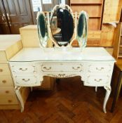 Cream dressing table with recessed front, pair slender flanking drawers, one frieze drawer,