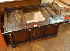 A reproduction stained oak coffer, with linenfold panel front, raised on bun feet, width 97cm,