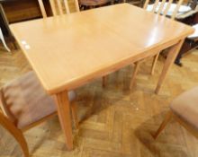 A Wyatt & Newton oak extending dining table with rectangular top and extra leaf,