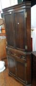 Georgian style oak corner cupboard, the panel doors enclosing shelves,