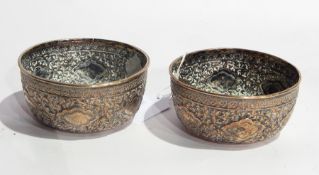 Pair of Eastern silver plate on copper bowls with foliate repousse decoration,