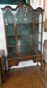 A Queen Anne style mahogany glazed bookcase with triple dome top,