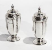 Pair of silver pepperettes with reeded body to raised circular foot, Birmingham 1910,