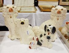 Pair Staffordshire pottery spaniels, 33cm high and three smaller,