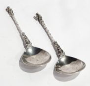 A pair of continental apostle spoons with spiral handles and figure finials,