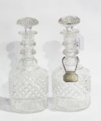 Two cut glass mallet-shaped decanters with triple ring necks, one having silver label "Sherry",