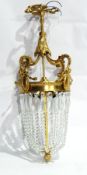 Gilt metal hanging lantern of cut glass lustres hanging in a tapering circular form,